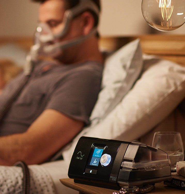 sleep-apnea-replacement-parts-airsense10-man-wearing-full-face-mask-in-bed